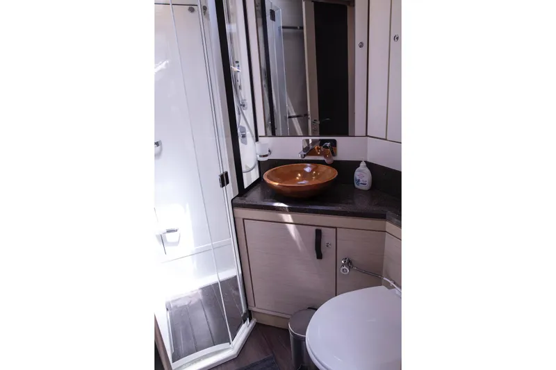  Yacht Photos Pics Luxurious bathroom in 2020 Jeanneau 64 yacht with modern fixtures and elegant design.