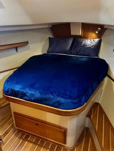 Pelican Yacht Photos Pics 2008 Island Packet 370 cabin with blue bedding and wooden accents.