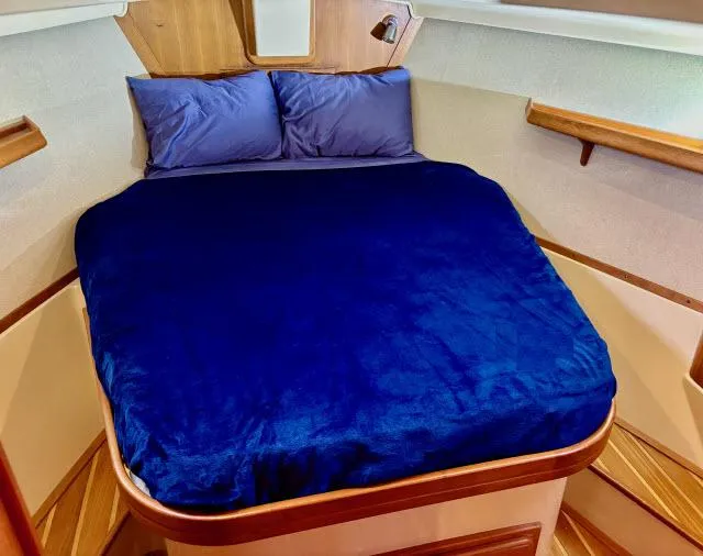 Pelican Yacht Photos Pics Cozy cabin bed in 2008 Island Packet 370 sailboat with blue bedding.