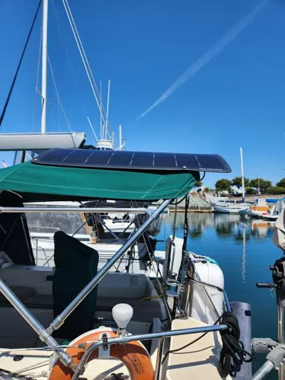 Pelican Yacht Photos Pics 2008 Island Packet 370 sailboat with solar panel, docked in a marina under clear blue skies.