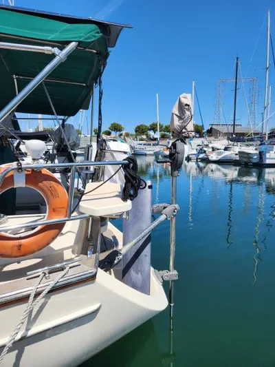 Pelican Yacht Photos Pics 2008 Island Packet 370 sailboat docked in a marina, clear blue sky, calm water.