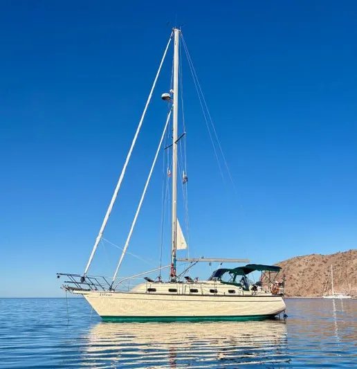 Pelican Yacht Photos Pics 2008 Island Packet 370 sailboat on calm water under clear blue sky.