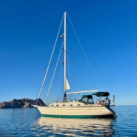 Pelican Yacht Photos Pics 2008 Island Packet 370 sailboat on calm water with clear blue sky.