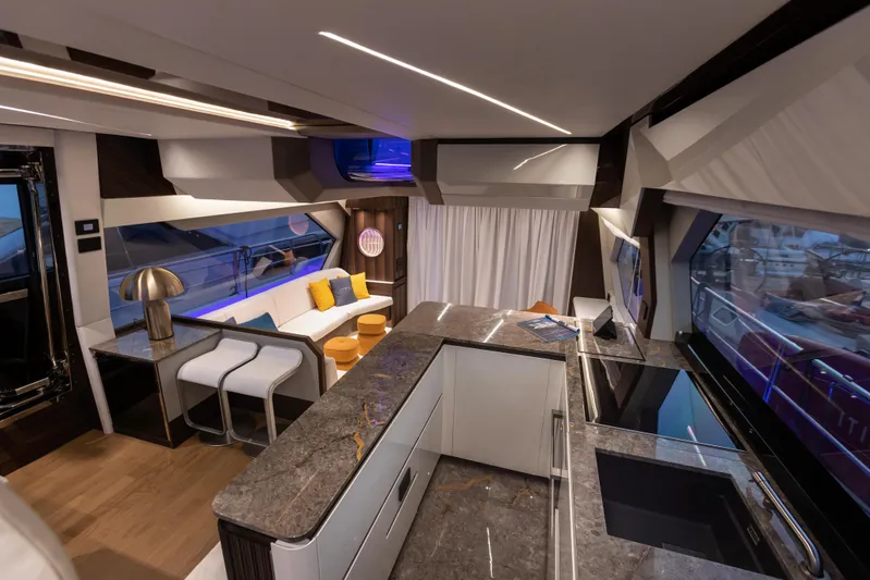  Yacht Photos Pics Luxurious interior of the 2024 Aicon Vivere 66' yacht with modern kitchen and seating area.