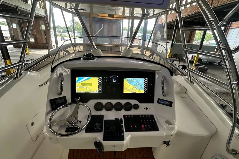  Yacht Photos Pics 2006 Sunseeker Sportfisher 37 helm with navigation screens and controls in a marina setting.