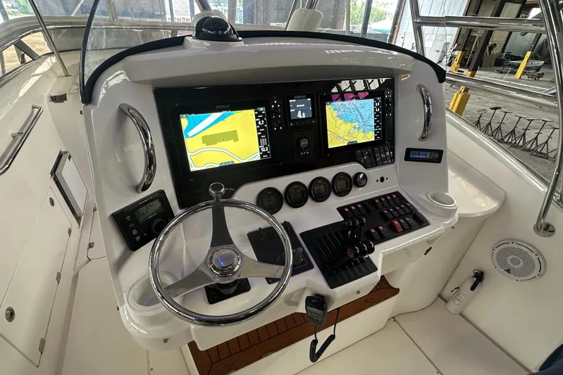  Yacht Photos Pics 2006 Sunseeker Sportfisher 37 helm with navigation screens and controls.