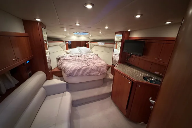  Yacht Photos Pics Luxurious interior of 2006 Sunseeker Sportfisher 37 yacht with cozy bed and elegant wood finish.