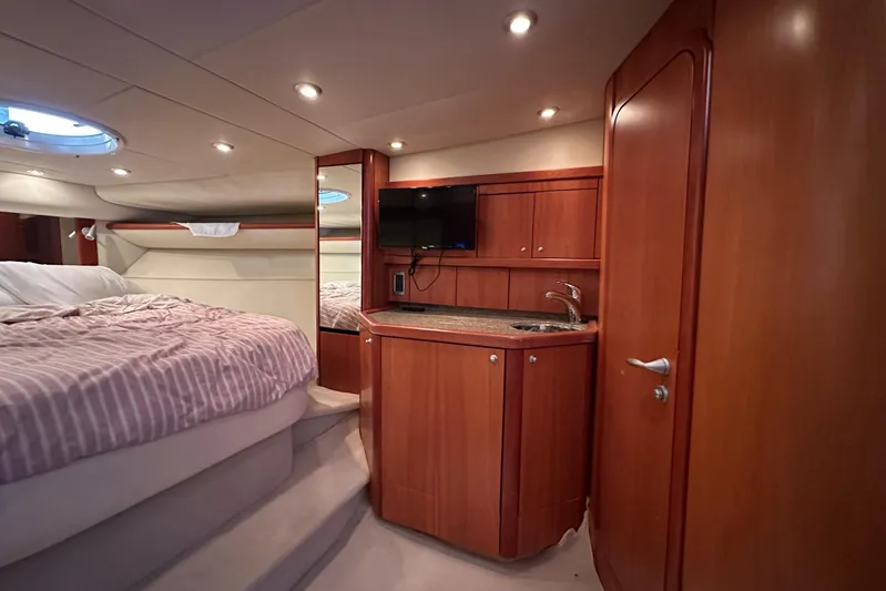  Yacht Photos Pics Luxurious interior of 2006 Sunseeker Sportfisher 37 yacht with bed, kitchenette, and TV.