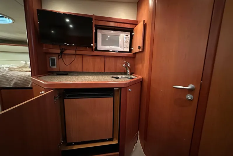  Yacht Photos Pics 2006 Sunseeker Sportfisher 37 interior with kitchenette, TV, and microwave.