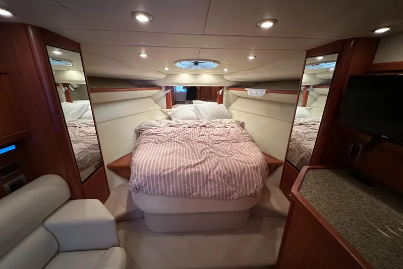  Yacht Photos Pics Luxurious cabin interior of 2006 Sunseeker Sportfisher 37 yacht with cozy bed and elegant decor.