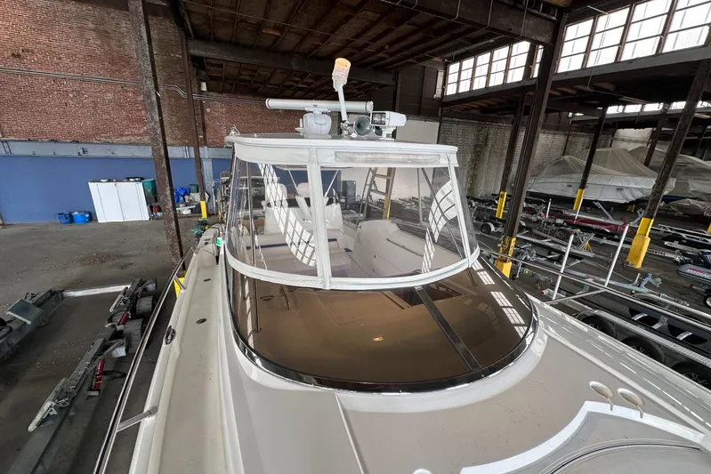  Yacht Photos Pics 2006 Sunseeker Sportfisher 37 boat in a warehouse, showcasing sleek design and spacious interior.