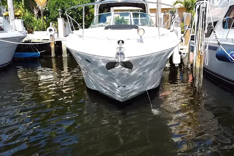  Yacht Photos Pics 2012 Sea Ray 330 Sundancer docked in marina, reflecting on calm water.