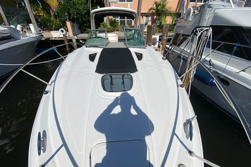  Yacht Photos Pics 2012 Sea Ray 330 Sundancer docked, showcasing sleek design and spacious deck.