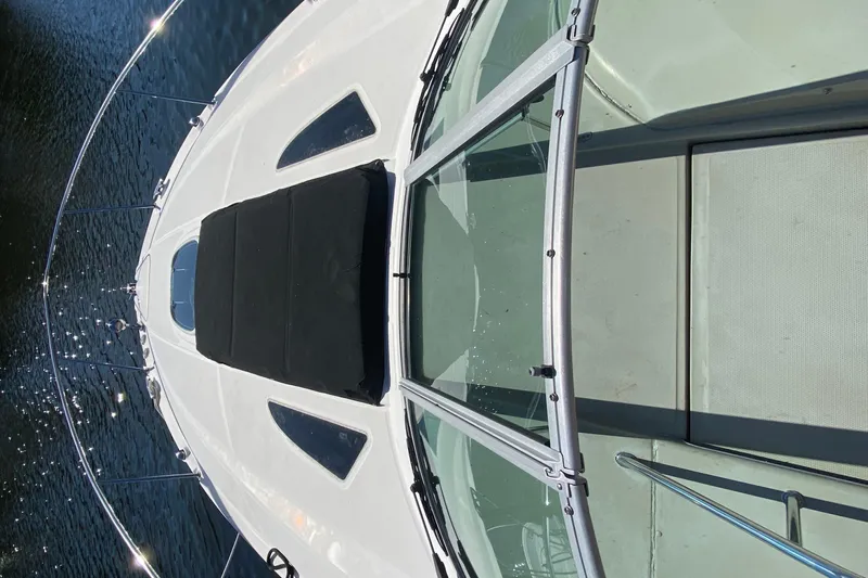  Yacht Photos Pics 2012 Sea Ray 330 Sundancer boat deck with glass windshield on water.