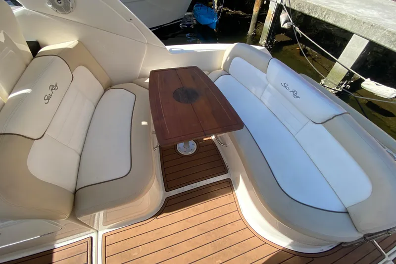  Yacht Photos Pics Luxurious seating area on 2012 Sea Ray 330 Sundancer yacht with wooden table.