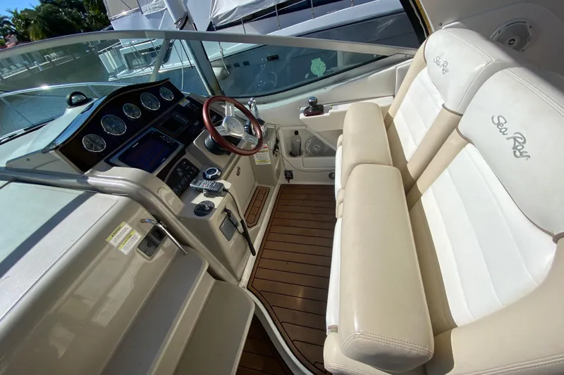  Yacht Photos Pics 2012 Sea Ray 330 Sundancer cockpit with leather seats and modern dashboard controls.