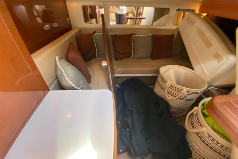  Yacht Photos Pics Interior of 2012 Sea Ray 330 Sundancer with seating, cushions, and storage baskets.