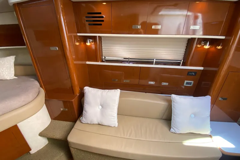  Yacht Photos Pics Luxurious interior of 2012 Sea Ray 330 Sundancer with beige seating and wooden cabinetry.