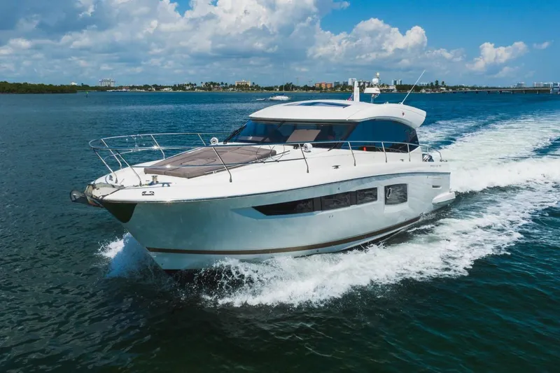  Yacht Photos Pics 2018 Prestige 500S yacht cruising on open water under a clear blue sky.