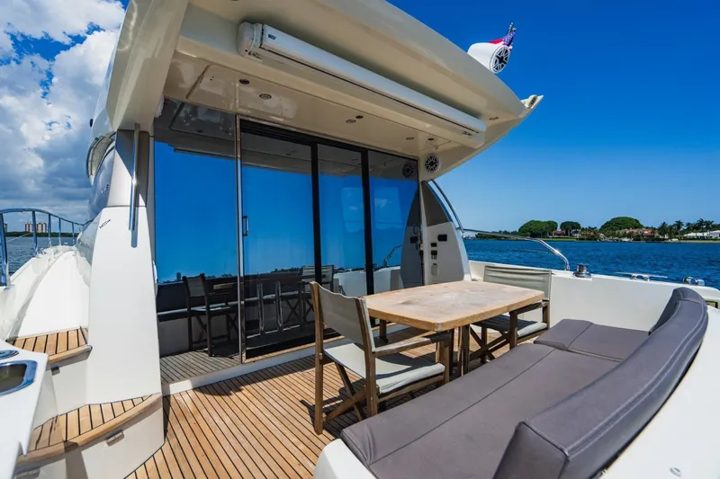  Yacht Photos Pics Prestige 500S 2018 yacht deck with seating, table, and ocean view under clear blue sky.