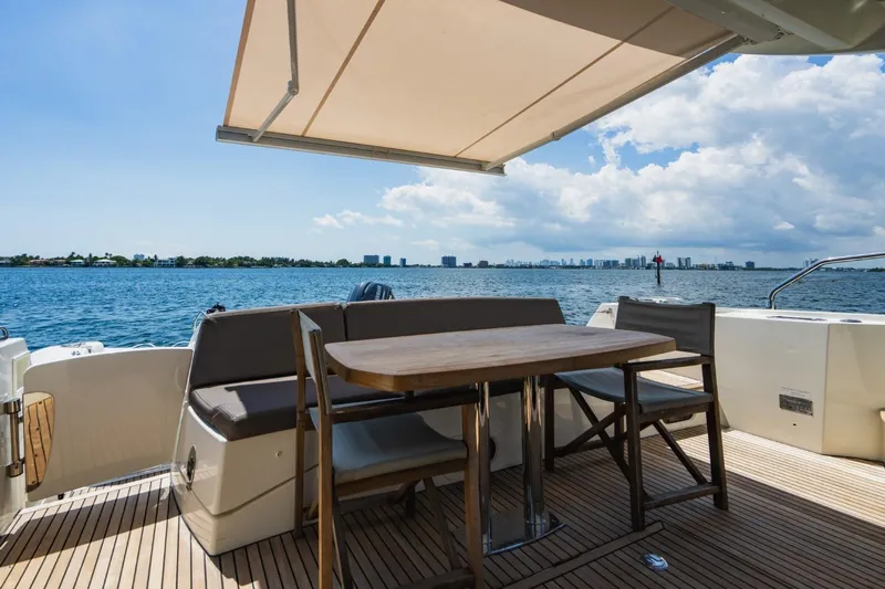 Yacht Photos Pics Prestige 500S 2018 yacht deck with seating, table, and ocean view under canopy.