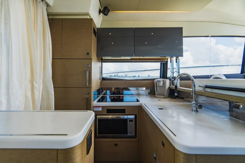  Yacht Photos Pics Luxurious kitchen interior of 2018 Prestige 500S yacht with modern appliances and sleek design.