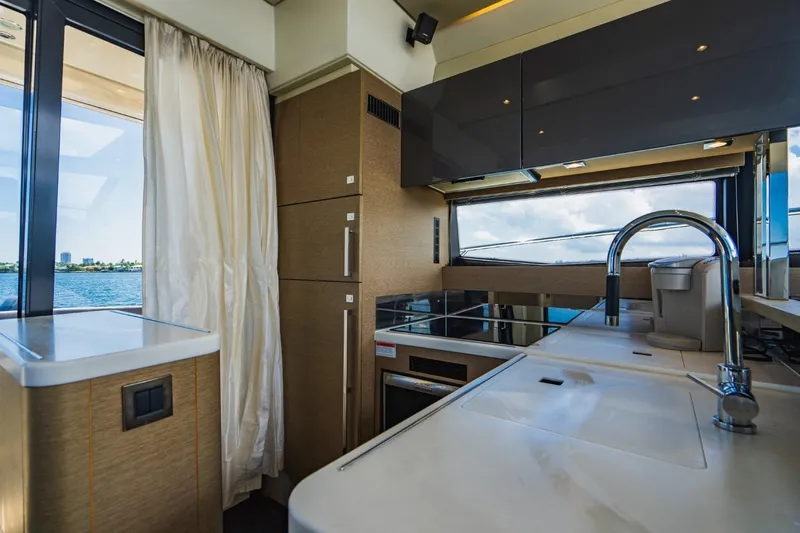  Yacht Photos Pics Luxurious kitchen interior of 2018 Prestige 500S yacht with modern amenities and scenic window view.