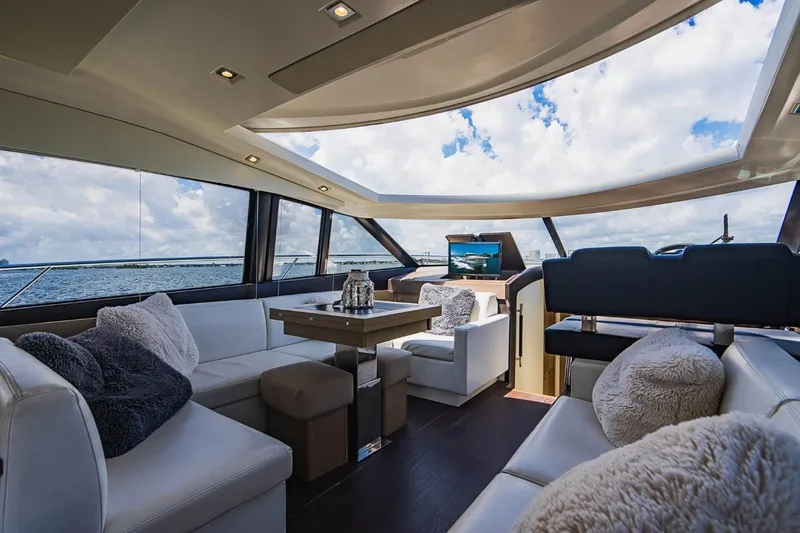  Yacht Photos Pics Luxurious interior of 2018 Prestige 500S yacht with panoramic windows and plush seating.