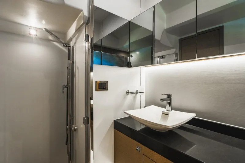  Yacht Photos Pics Modern bathroom interior on 2018 Prestige 500S yacht, featuring sleek sink and mirrored cabinets.
