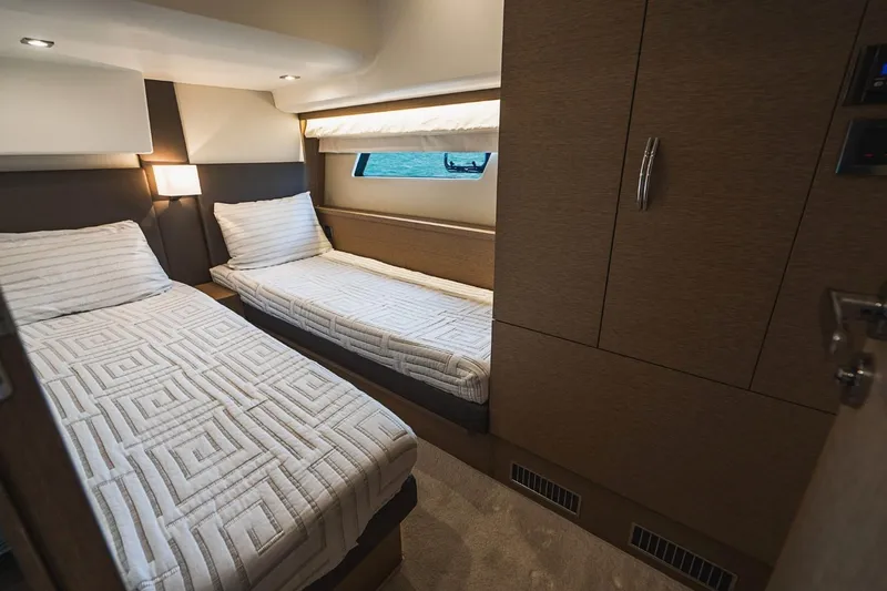  Yacht Photos Pics Interior of 2018 Prestige 500S yacht cabin with twin beds and modern decor.