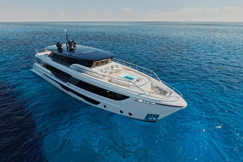  Yacht Photos Pics Luxurious 2023 Majesty 111 yacht cruising on clear blue ocean waters.