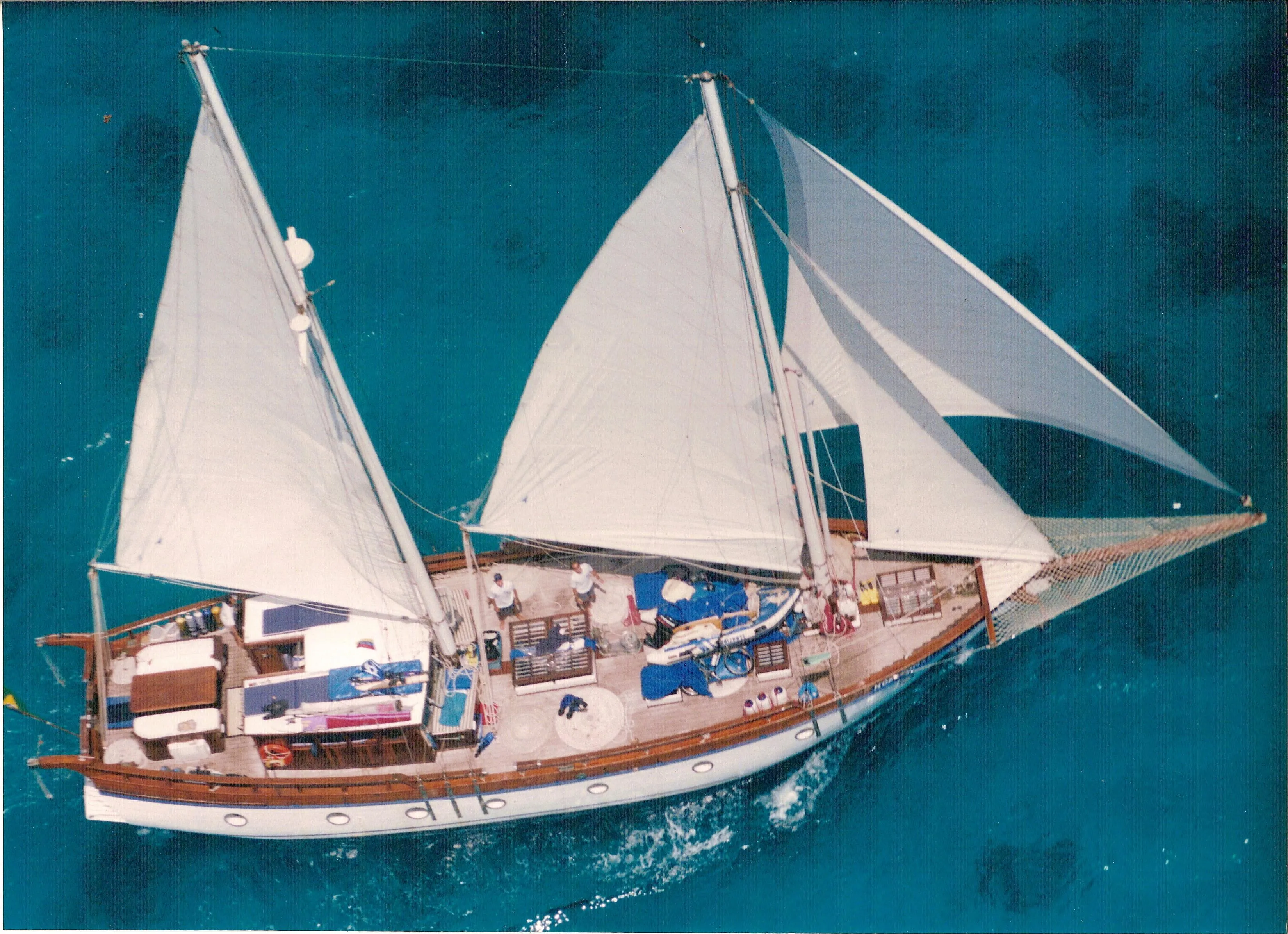 Aerial view of 1991 Custom Horacio Carabelli Schooner sailing on clear blue water.