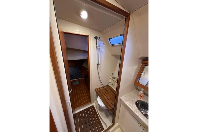 Murrelet Yacht Photos Pics 2009 Hunter 38 yacht bathroom with shower, wooden accents, and compact design.