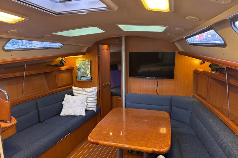 Murrelet Yacht Photos Pics Interior of 2009 Hunter 38 sailboat with cozy seating and wooden table.