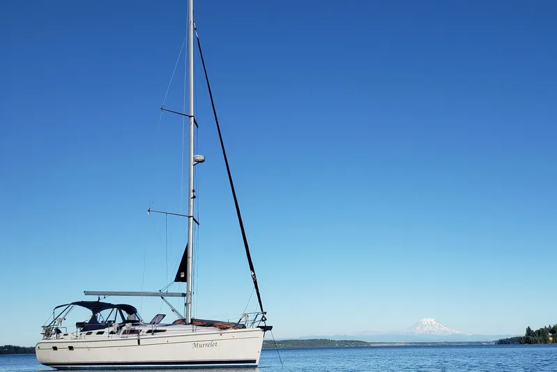 Murrelet Yacht Photos Pics 2009 Hunter 38 sailboat on calm water with mountain backdrop.