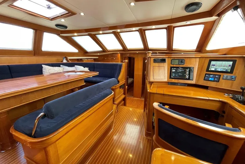  Yacht Photos Pics Luxurious interior of a 1999 Baltic 73 Pilothouse yacht with wood finishes and navigation equipment.