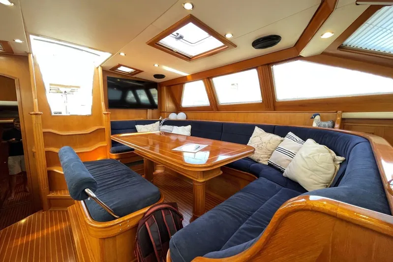 Yacht Photos Pics Luxurious interior of 1999 Baltic 73 Pilothouse yacht with plush seating and wooden finishes.
