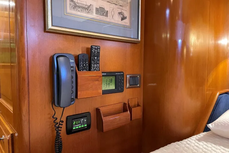  Yacht Photos Pics Interior of 1999 Baltic 73 Pilothouse with communication devices and wooden paneling.