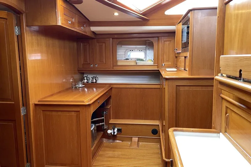  Yacht Photos Pics Luxurious wooden interior of a 1999 Baltic 73 Pilothouse yacht kitchen.