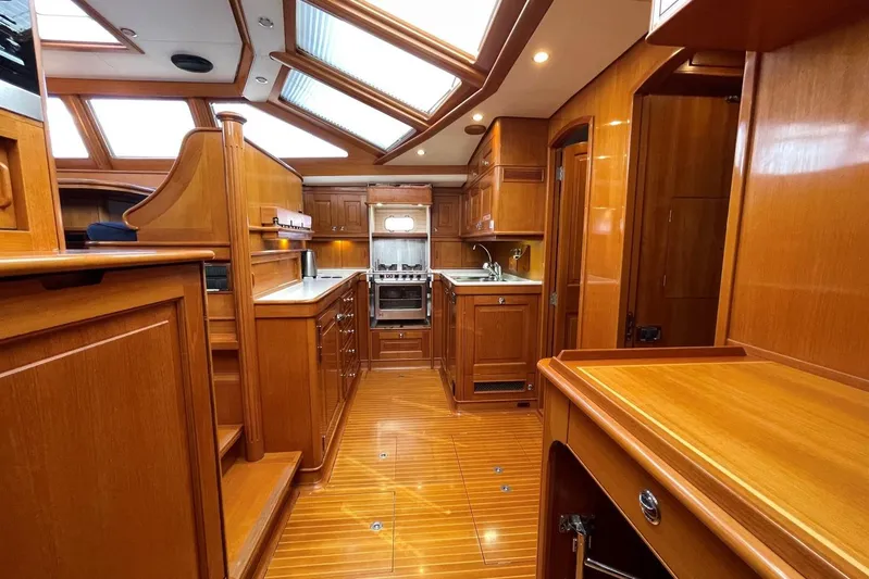  Yacht Photos Pics Luxurious wooden interior of a 1999 Baltic 73 Pilothouse yacht kitchen.