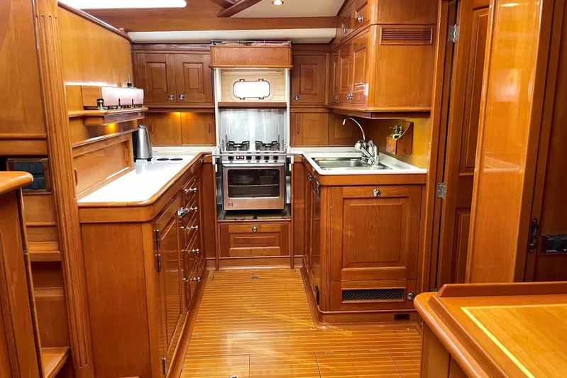  Yacht Photos Pics Luxurious wooden kitchen interior of 1999 Baltic 73 Pilothouse yacht.
