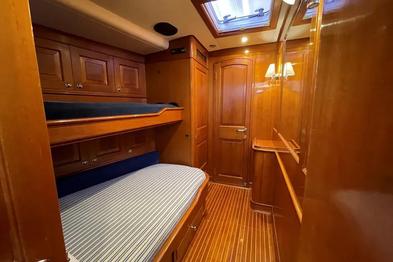  Yacht Photos Pics Luxurious wooden cabin interior of 1999 Baltic 73 Pilothouse yacht with bunk beds.