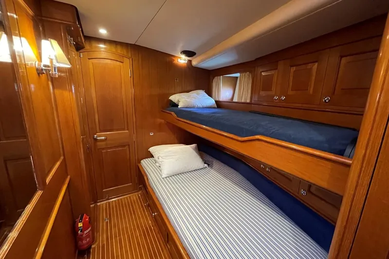  Yacht Photos Pics Luxurious wooden cabin interior of 1999 Baltic 73 Pilothouse yacht with bunk beds.