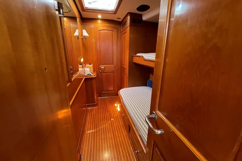  Yacht Photos Pics Luxurious wooden interior of 1999 Baltic 73 Pilothouse yacht cabin with bunk beds.