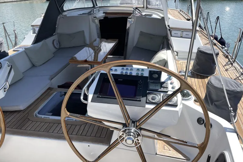  Yacht Photos Pics Luxurious 1999 Baltic 73 Pilothouse yacht cockpit with wooden steering wheel and seating area.