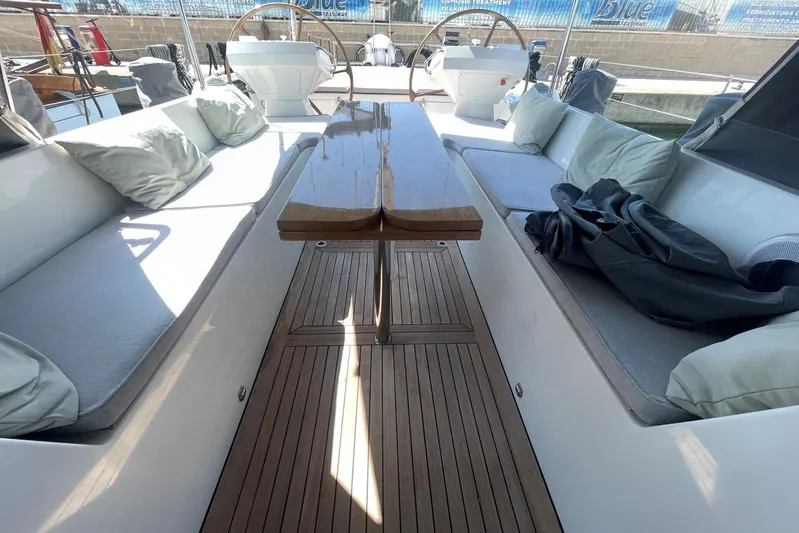  Yacht Photos Pics Luxurious 1999 Baltic 73 Pilothouse yacht interior with cushioned seating and wooden table.