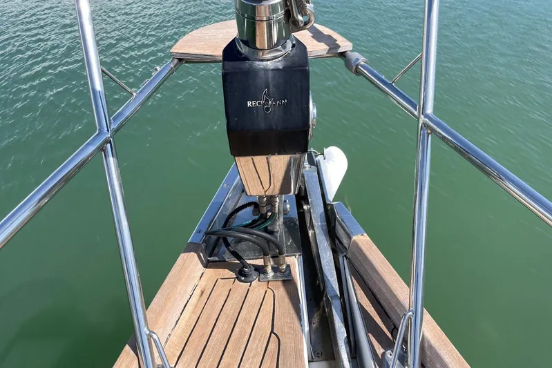  Yacht Photos Pics Bow of 1999 Baltic 73 Pilothouse yacht with anchor mechanism, on calm water.