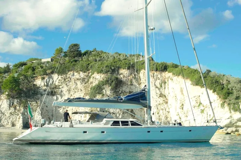  Yacht Photos Pics Sailing yacht Baltic 73 Pilothouse 1999 near rocky coastline under blue sky.