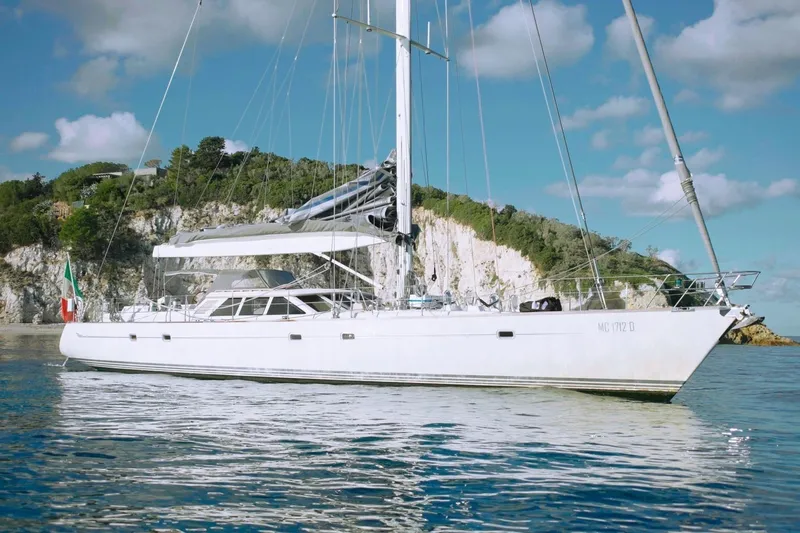  Yacht Photos Pics Sailing yacht Baltic 73 Pilothouse 1999 on calm waters near rocky coastline.