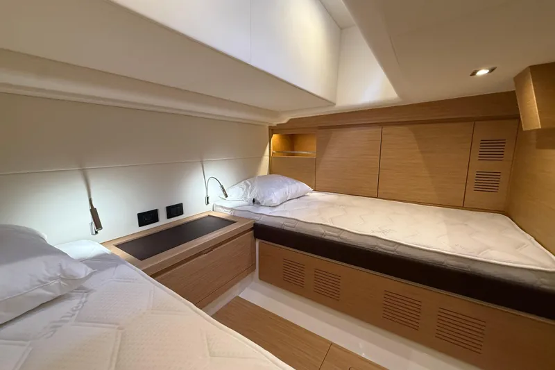 George Yacht Photos Pics Luxurious cabin interior of 2024 Pardo Yachts 43, featuring modern wood finishes and cozy bedding.
